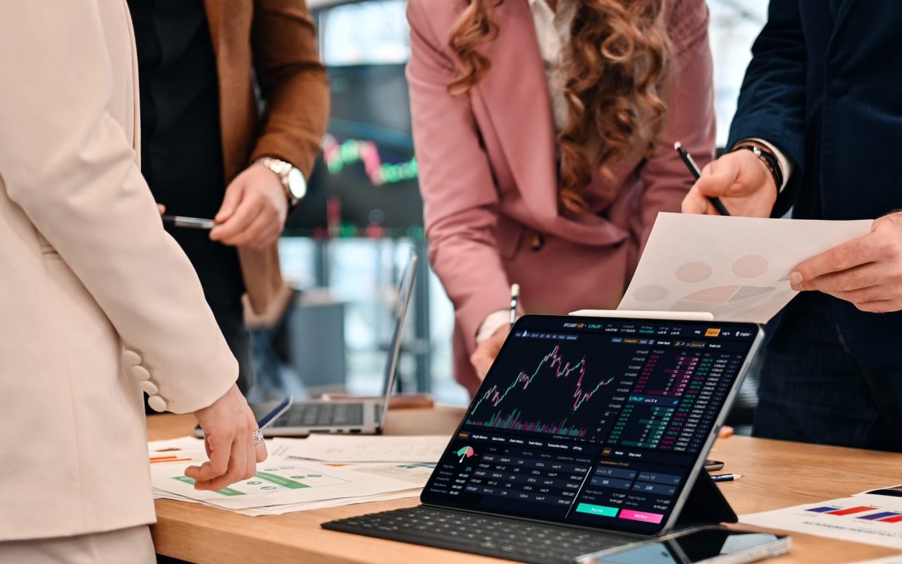 Business meeting in an office, workers discussing business affairs using gadgets and papers with charts